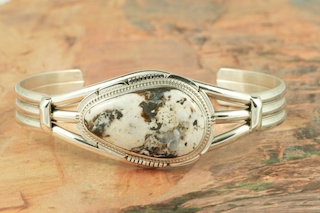White Buffalo Turquoise set in heavy gauge Sterling Silver. This Beautiful Stone is formed from the minerals Calcite and Iron. It is mined near Tonopah Nevada. Created by Navajo Artist Kathy Yazzie. Signed by the artist.
